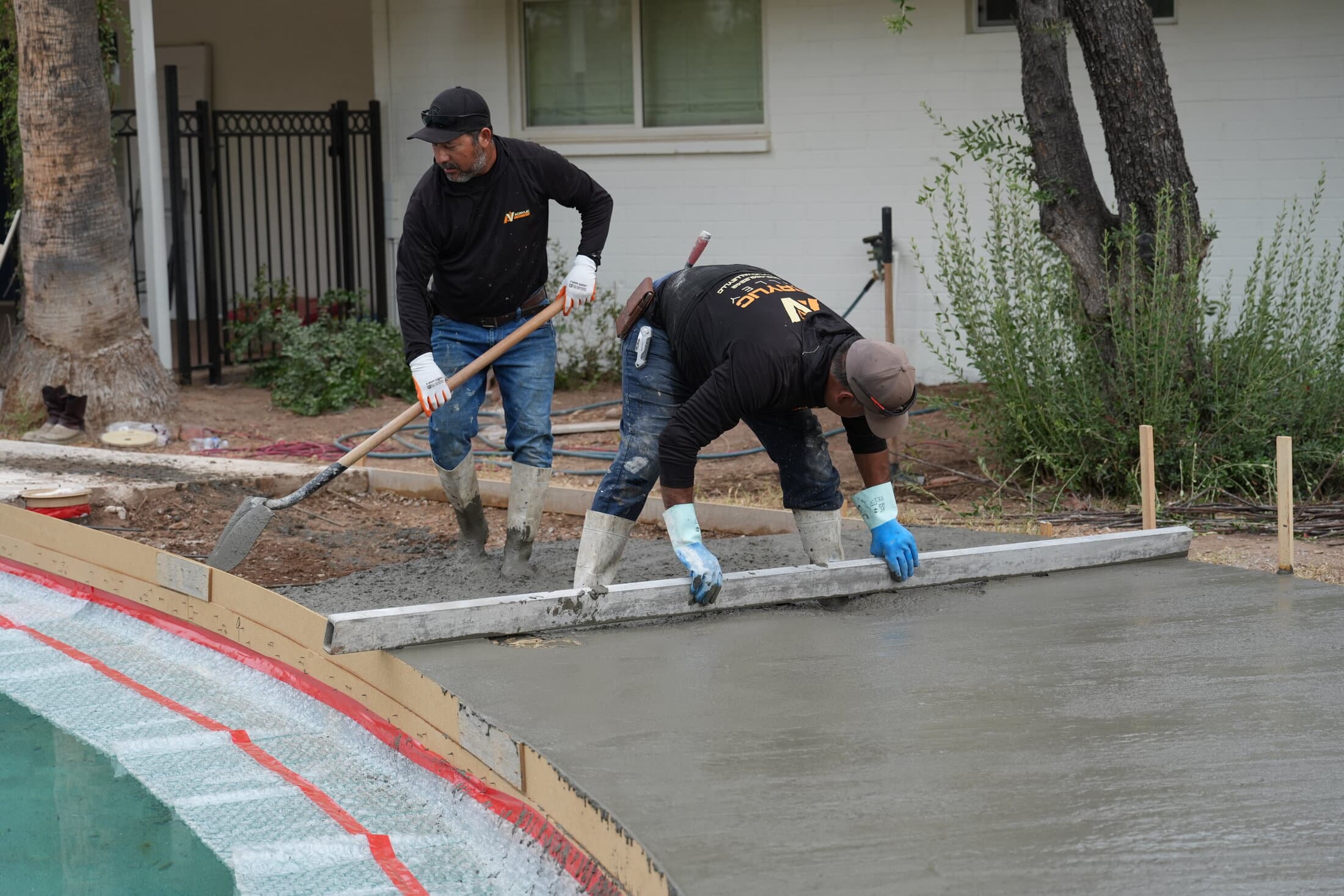 Acrylic Valley crew screeding a freshly poured concrete slab